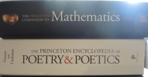 A picture of the Sun peeking over the spine of The Princeton Companion to Mathematics as it rests on top of The Princeton Encyclopedia of Poetry & Poetics