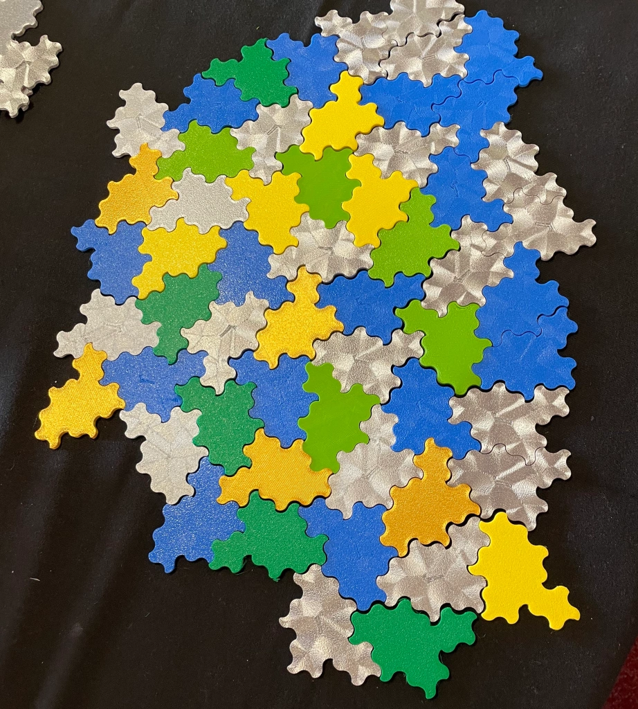 A whole lot of plastic tiles, all in the same complex, curvy shape, tiled together. They fit together in a way that doesn't allow the pattern to repeat.
